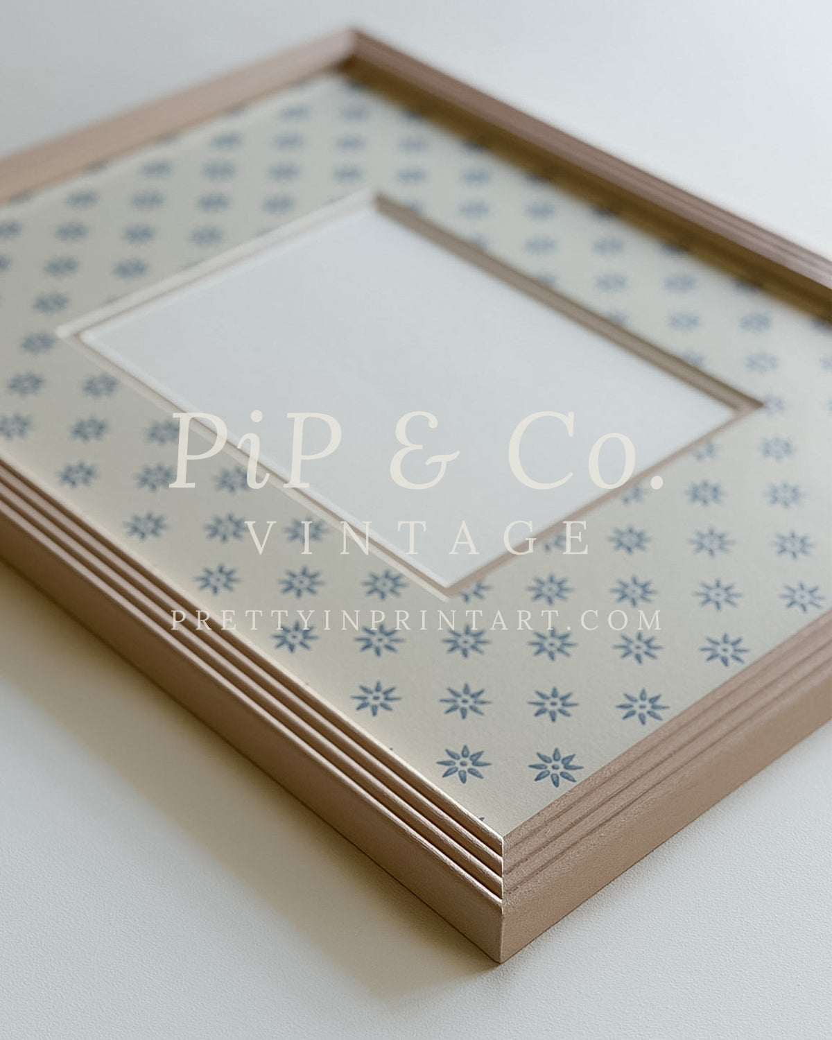 Hand painted reeded picture frame in Farrow and Ball Setting Plaster with Borastapeter Skogsstjarna wallpaper mount.