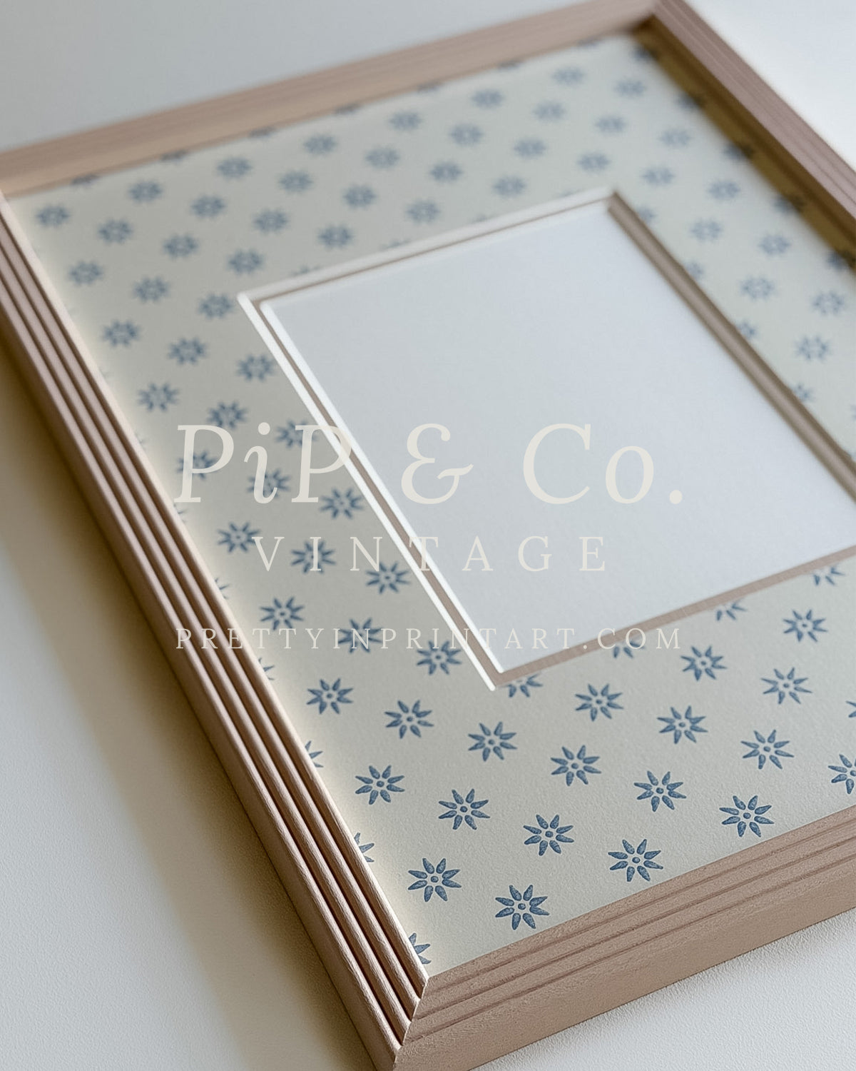 Hand painted reeded picture frame in Farrow and Ball Setting Plaster with Borastapeter Skogsstjarna wallpaper mount.