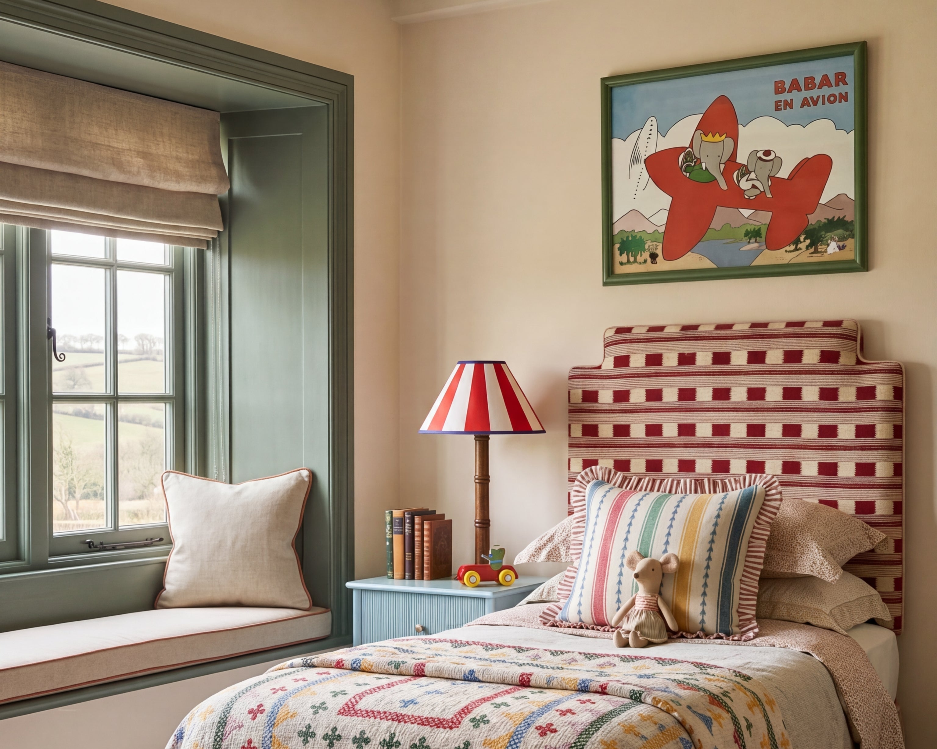 Babar the Elephant nursery art print in an olive green frame above a red gingham daybed, from Pretty in Print Art's Babar nursery art prints collection