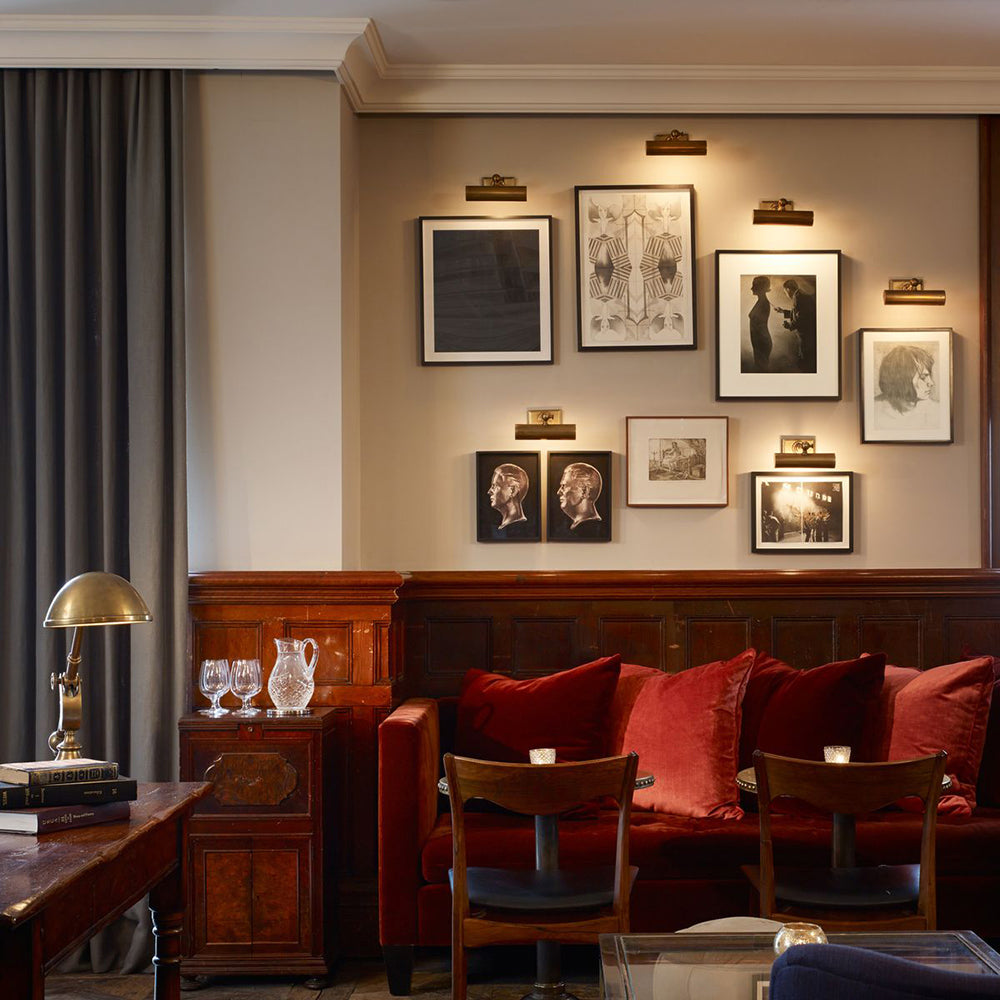 Pub interior with framed prints on the wall.
