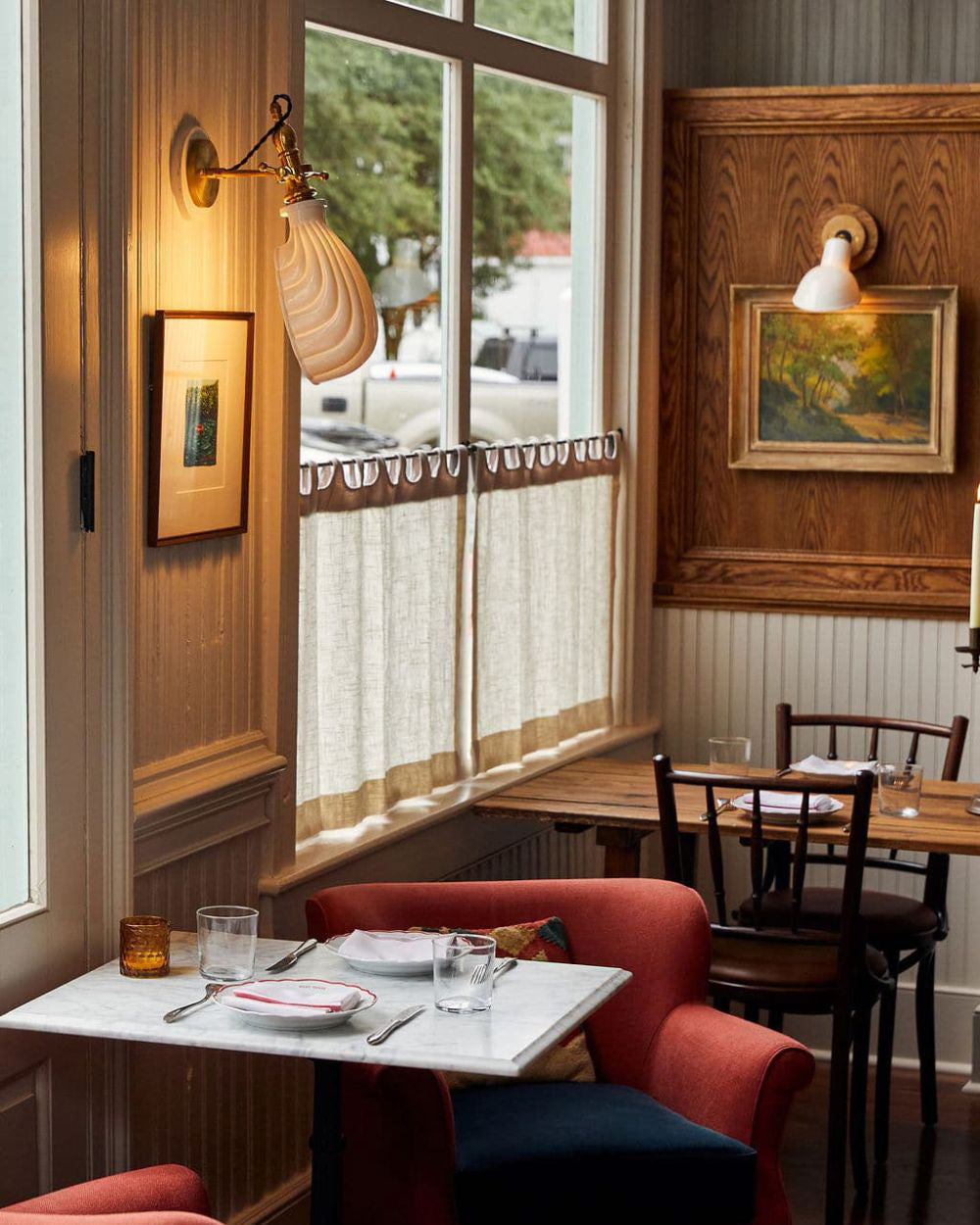 Pub interior with framed prints on the wall.