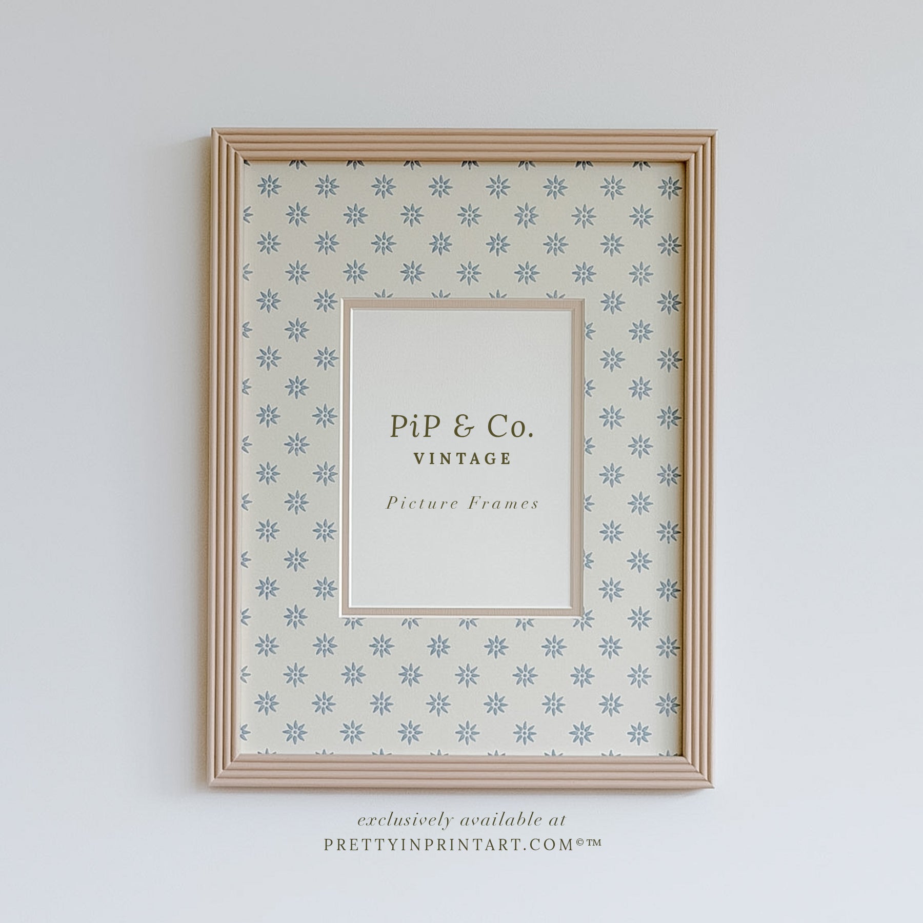 Hand painted reeded picture frame in Farrow and Ball Setting Plaster with Borastapeter Skogsstjarna wallpaper mount.