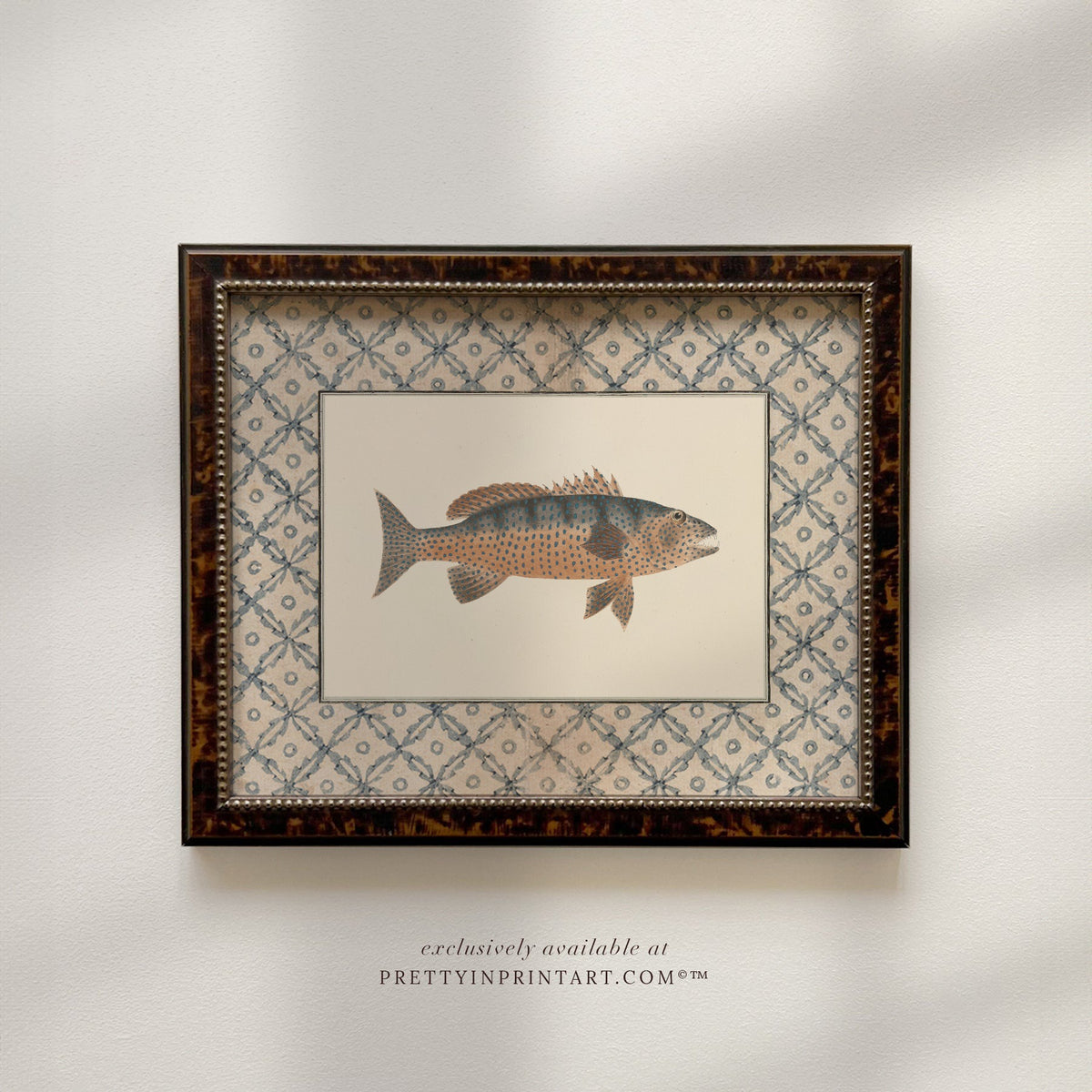 Vintage spotted amber and slate fish art print with a blue lattice border in a tortoiseshell-style wooden frame, front view