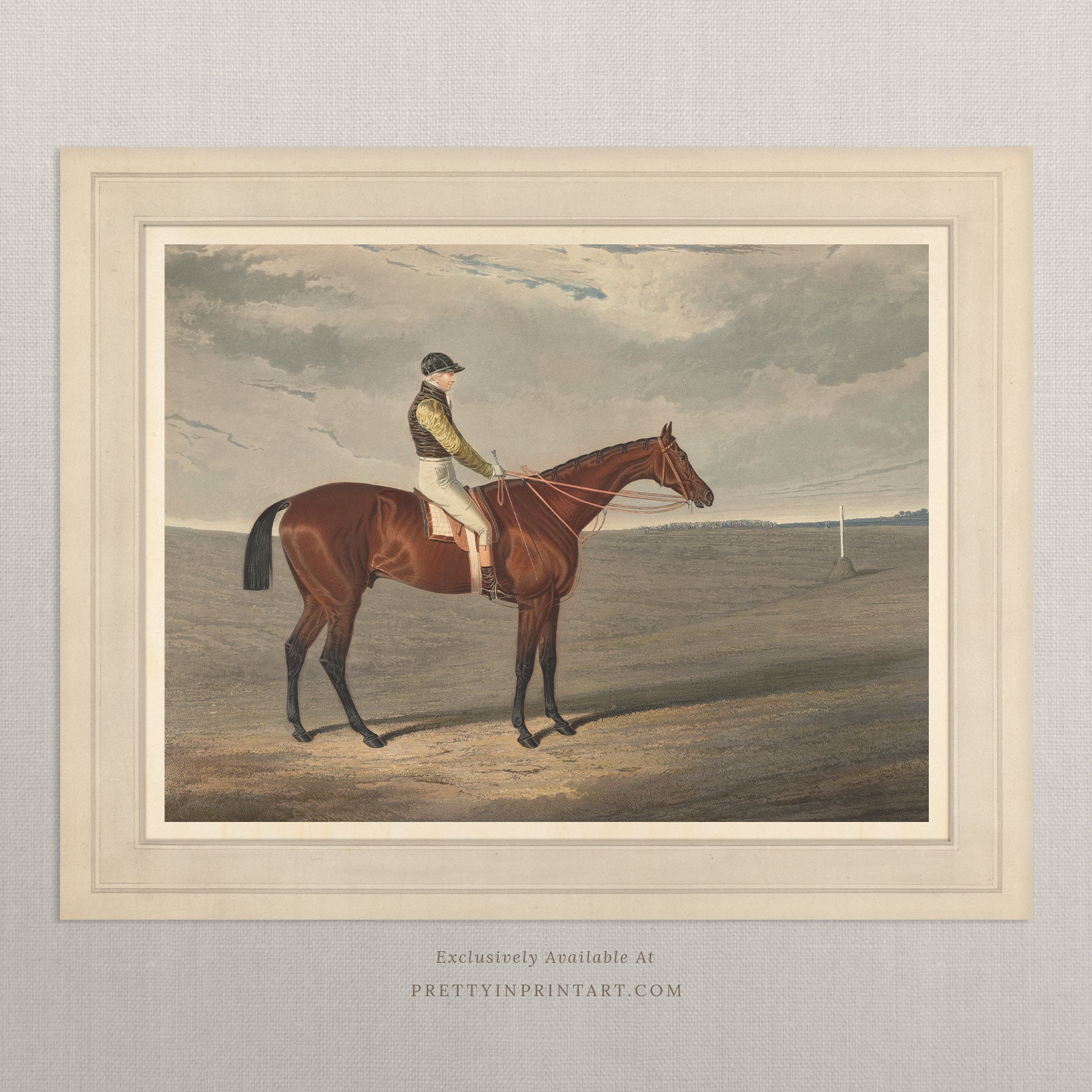 Framed artwork of a jockey on a horse with a landscape background