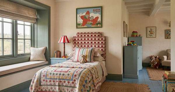 Framed Babar print above a bed in a children's bedroom