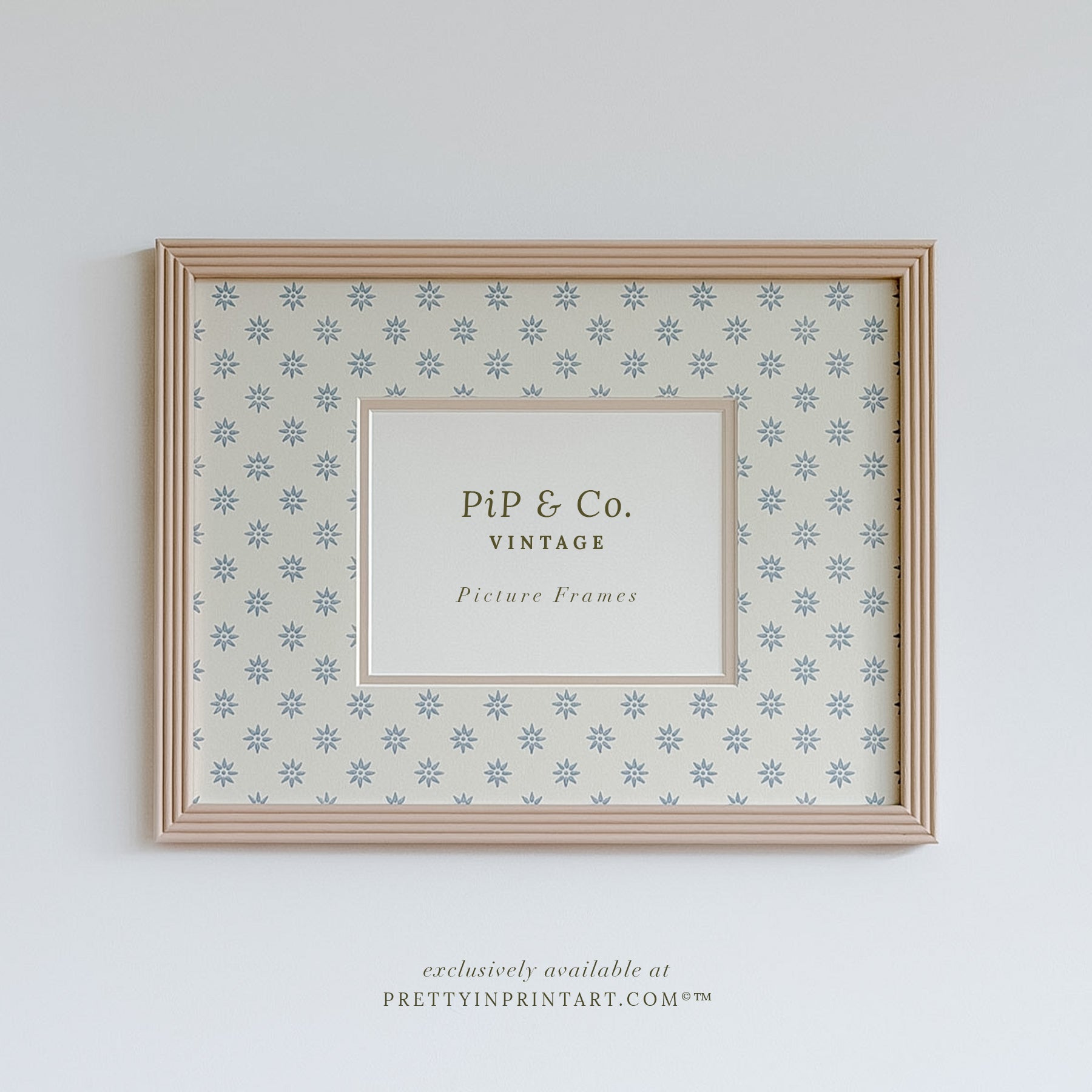 Hand painted reeded picture frame in Farrow and Ball Setting Plaster with Borastapeter Skogsstjarna wallpaper mount.