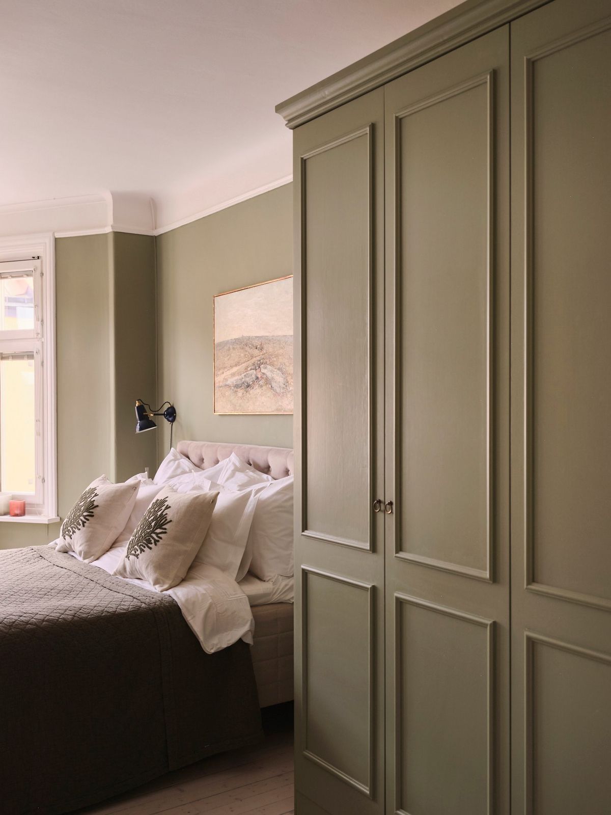 Sage green built in wardrobes.